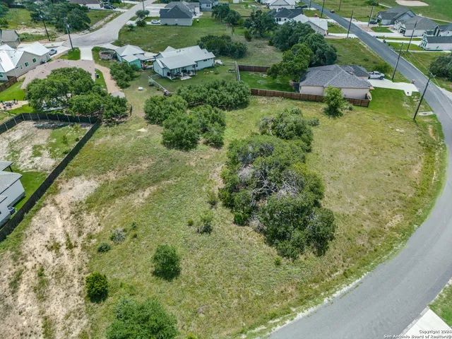 an aerial view of a house with a yard