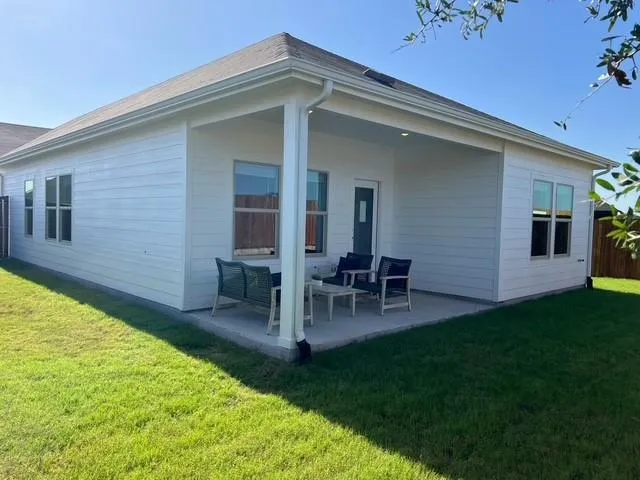 a view of an house with backyard porch and furniture