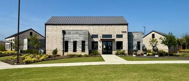 a front view of a house with a yard table and chairs