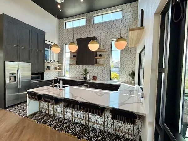a kitchen with a table chairs and a refrigerator