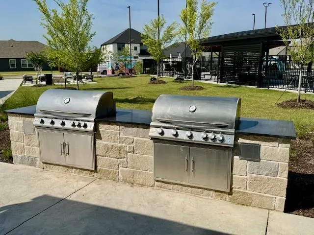 a view of a patio with table and chairs under an umbrella
