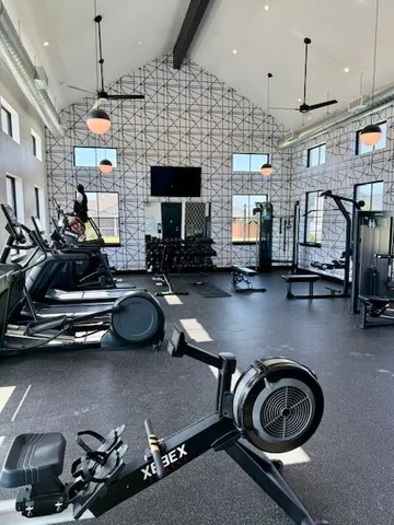 a room with gym equipment and a flat screen tv