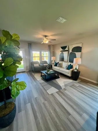 a living room with furniture and a chandelier
