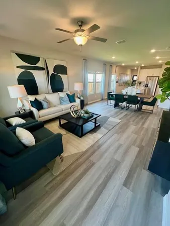 a living room with furniture and a chandelier