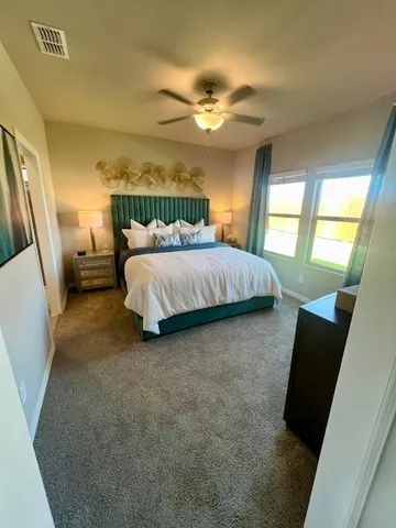 a spacious bedroom with a bed and window