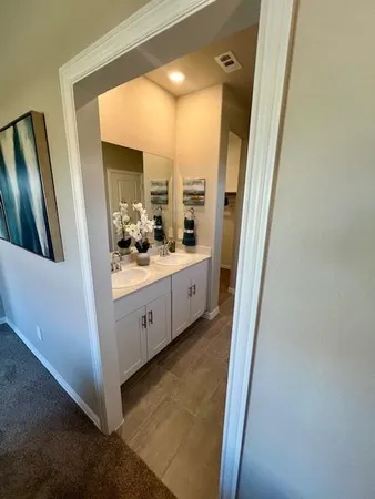 a bathroom with a double vanity sink and mirror