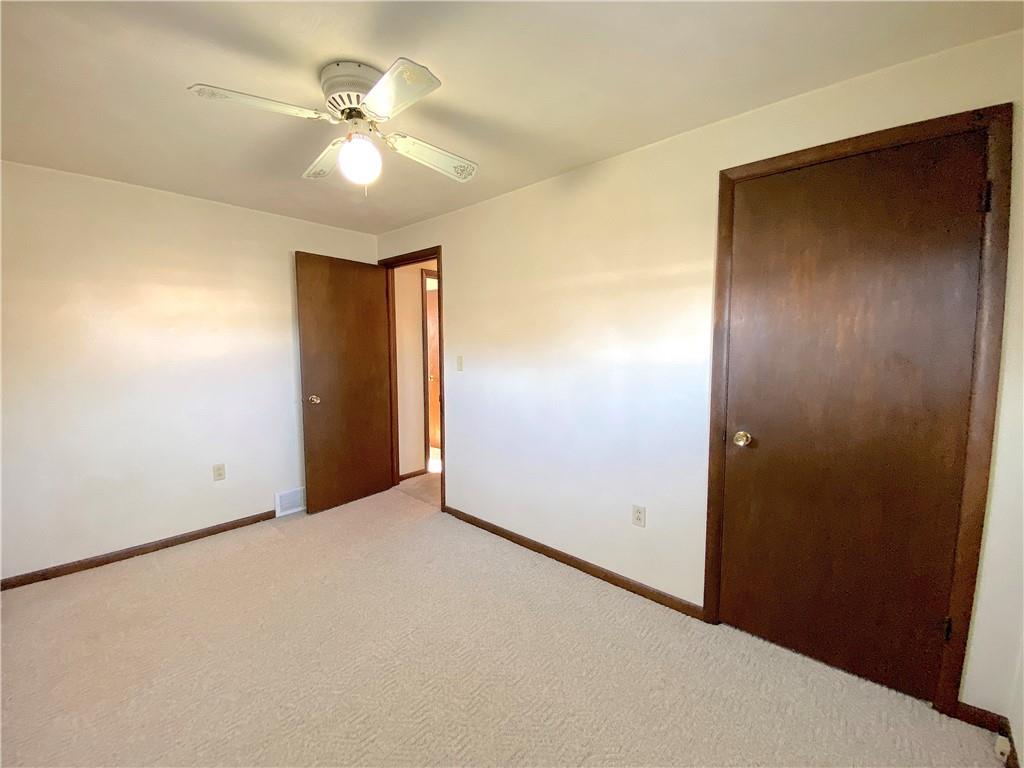 1821 Cowling Road Scottdale, PA 15683 - Photo 15 of 24 an empty room with closet and a ceiling fan