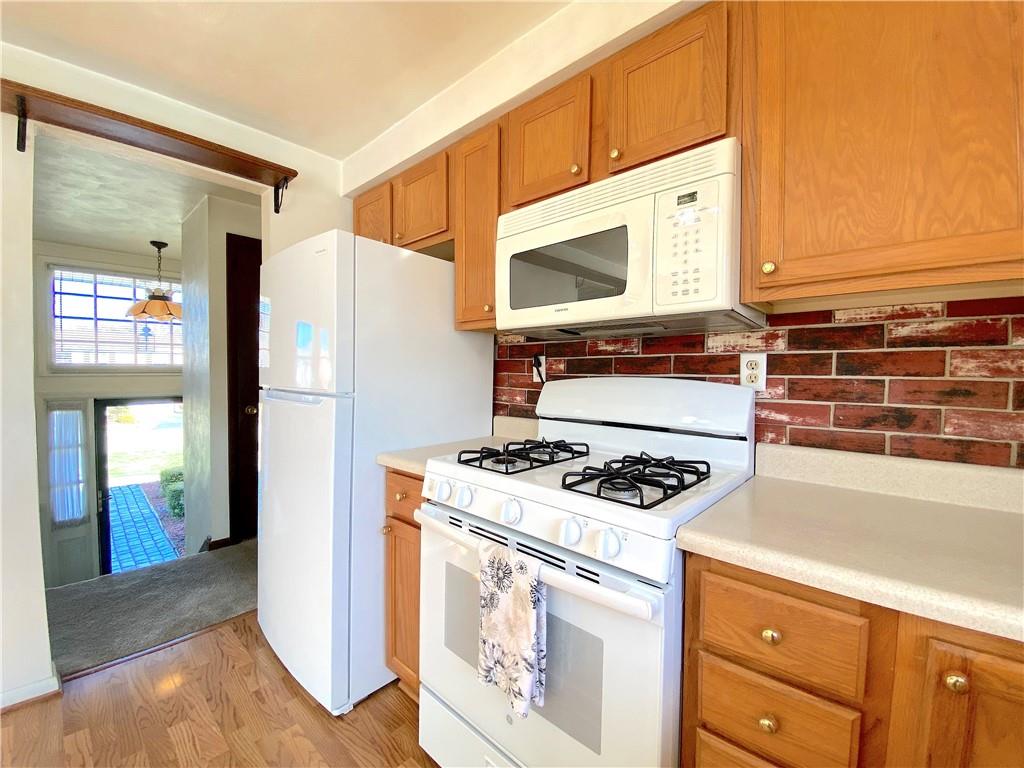 1821 Cowling Road Scottdale, PA 15683 - Photo 9 of 24 a kitchen with stainless steel appliances granite countertop a stove and a refrigerator