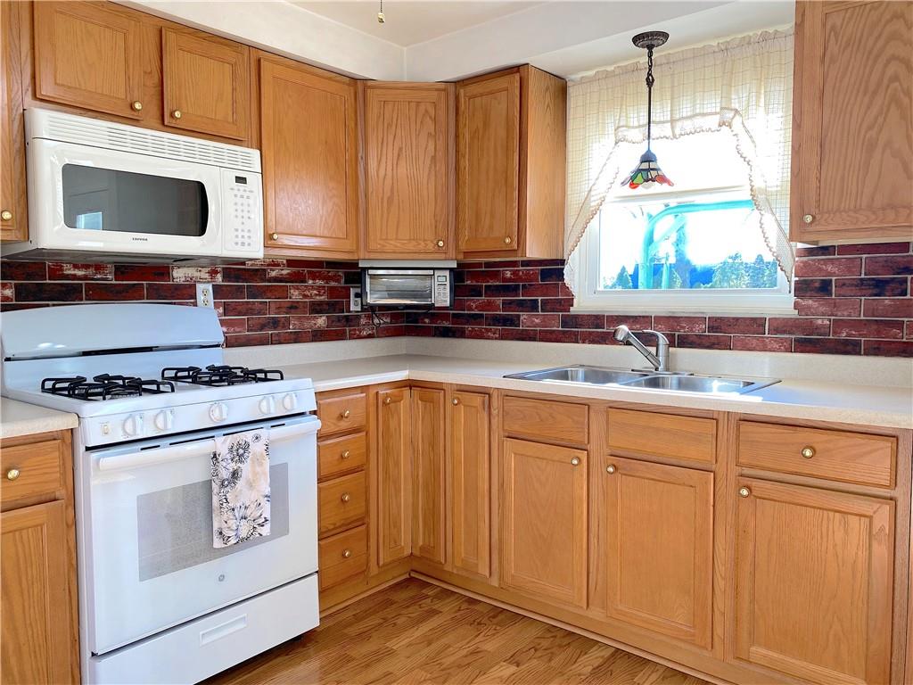 1821 Cowling Road Scottdale, PA 15683 - Photo 10 of 24 a kitchen with stainless steel appliances granite countertop a stove a sink and a microwave