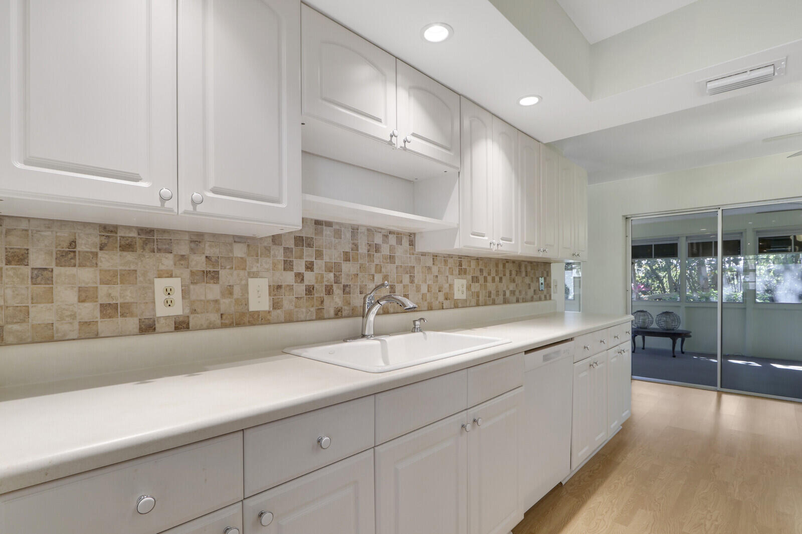 8574 Southeast Seagrape Way Hobe Sound, FL 33455 - Photo 17 of 38 a kitchen with a sink and cabinets