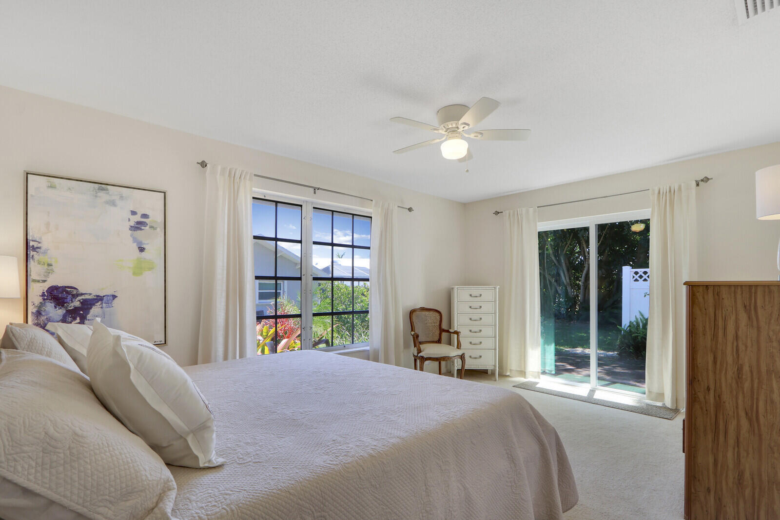 8574 Southeast Seagrape Way Hobe Sound, FL 33455 - Photo 24 of 38 a bedroom with a bed and a large window