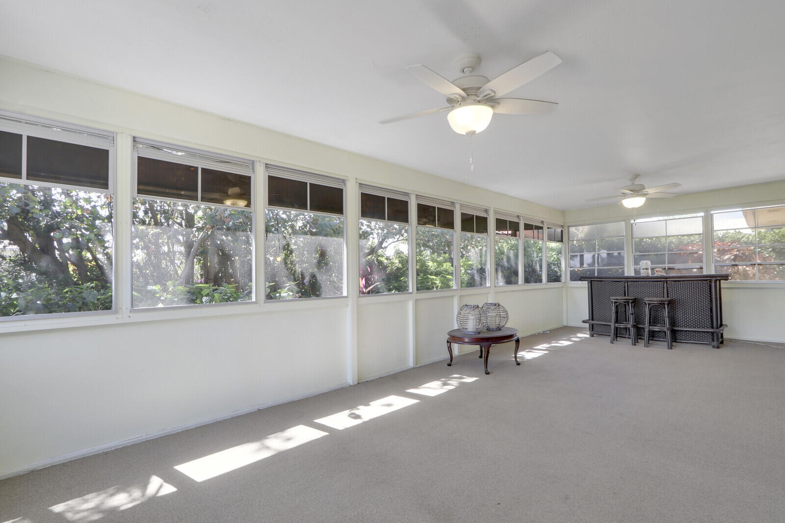 8574 Southeast Seagrape Way Hobe Sound, FL 33455 - Photo 29 of 38 a living room with furniture and flowers