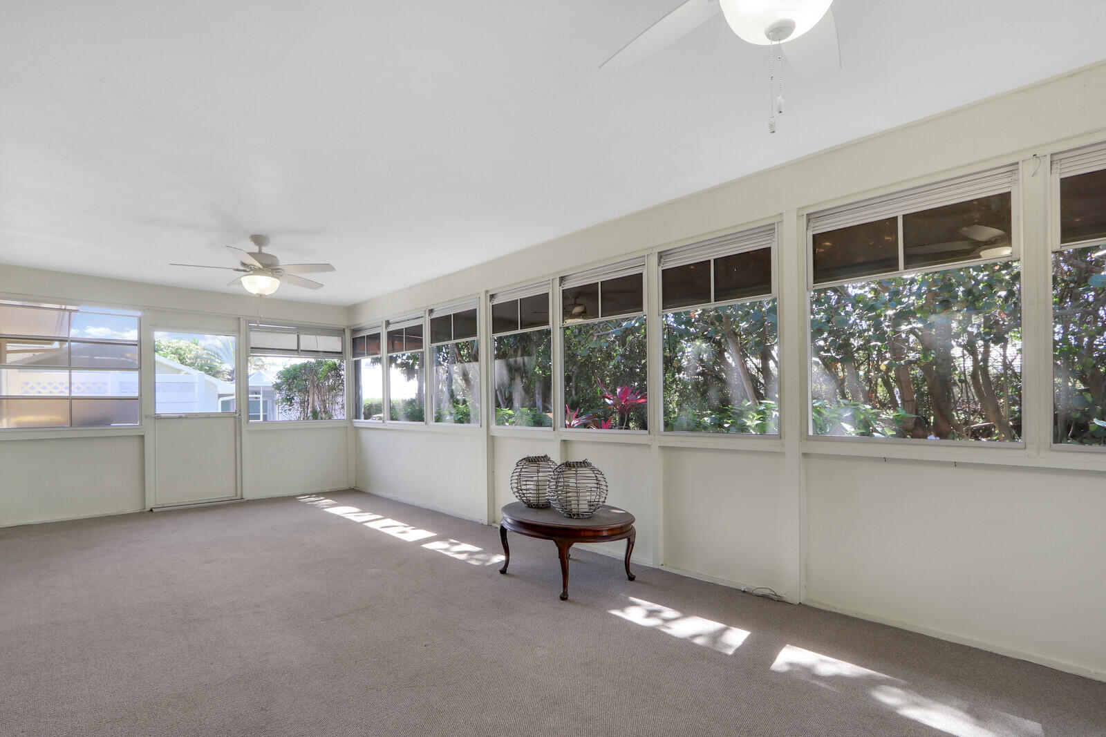 8574 Southeast Seagrape Way Hobe Sound, FL 33455 - Photo 30 of 38 a living room with furniture and a potted plant