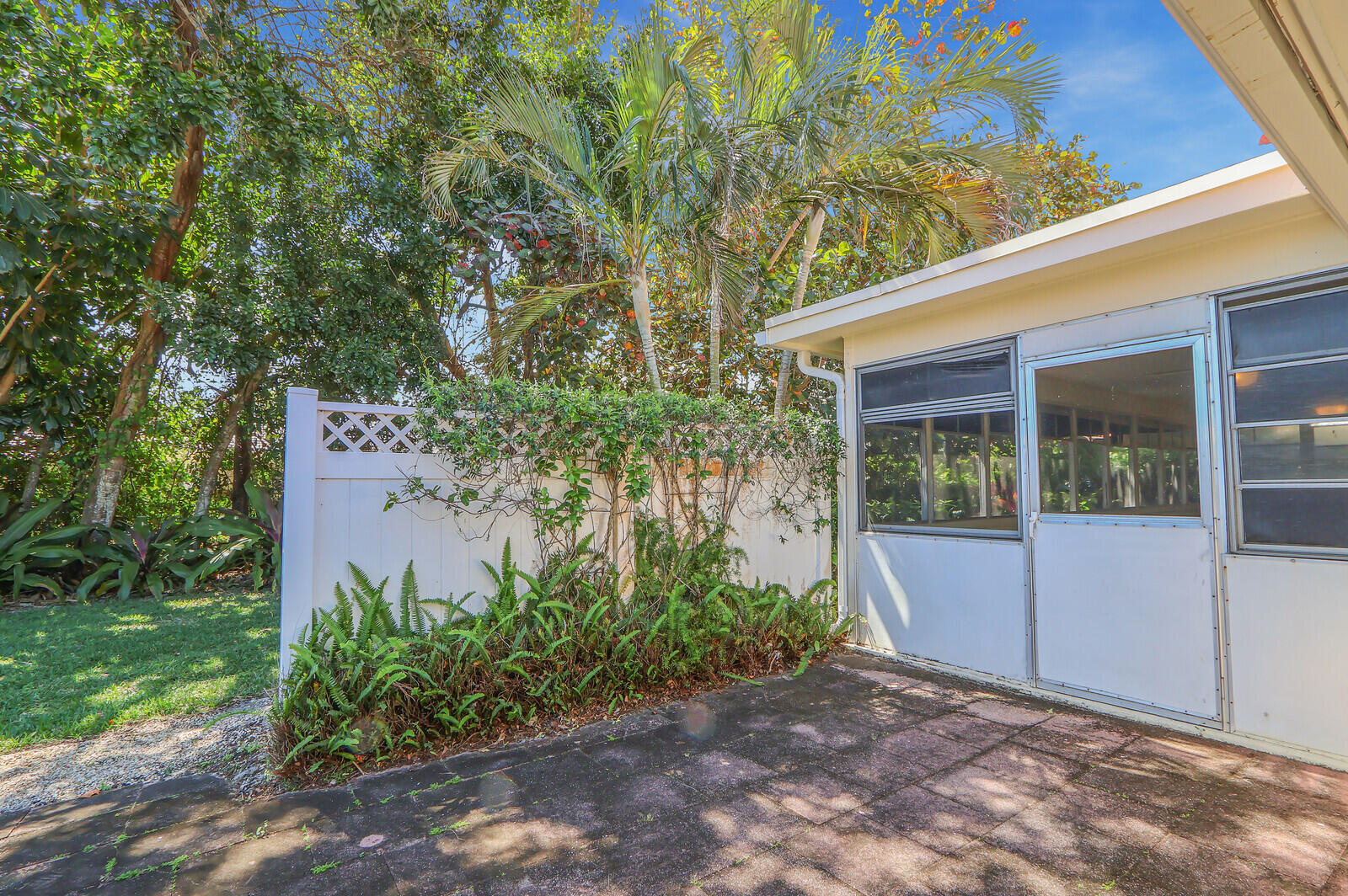 8574 Southeast Seagrape Way Hobe Sound, FL 33455 - Photo 32 of 38 a view of a house with backyard and garden
