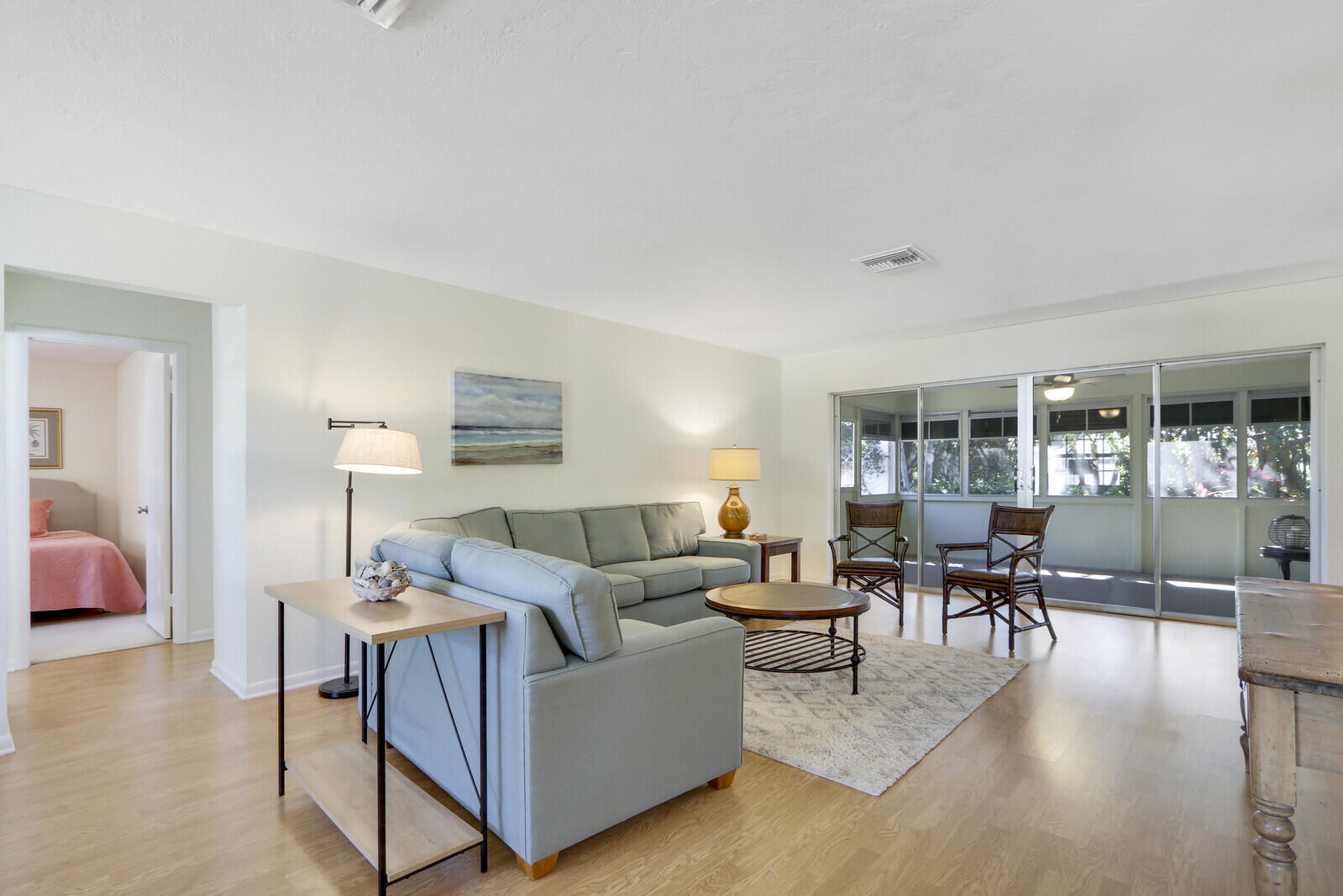 8574 Southeast Seagrape Way Hobe Sound, FL 33455 - Photo 7 of 38 a living room with furniture and a table