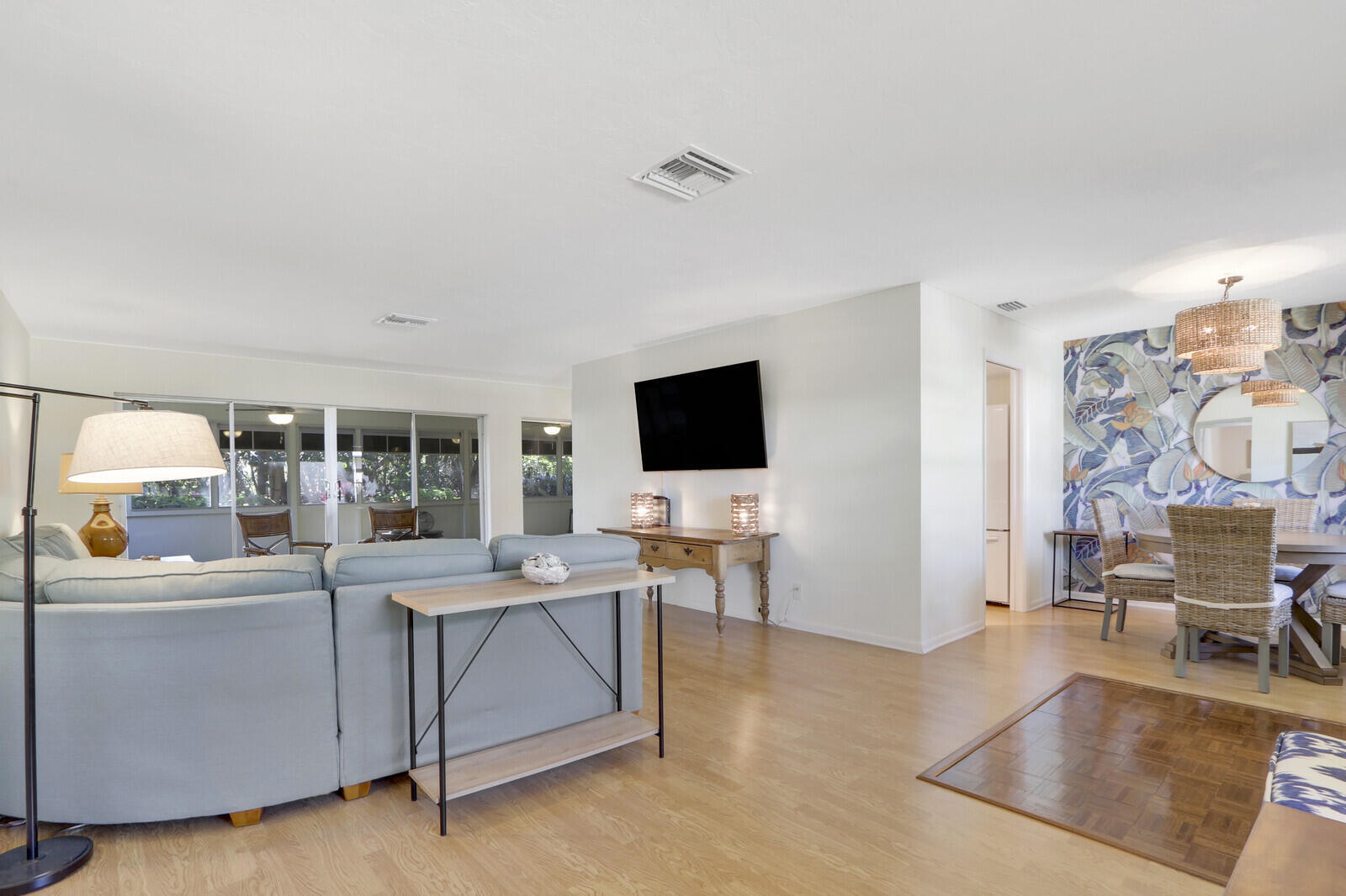8574 Southeast Seagrape Way Hobe Sound, FL 33455 - Photo 8 of 38 a living room with a flat screen tv and a table