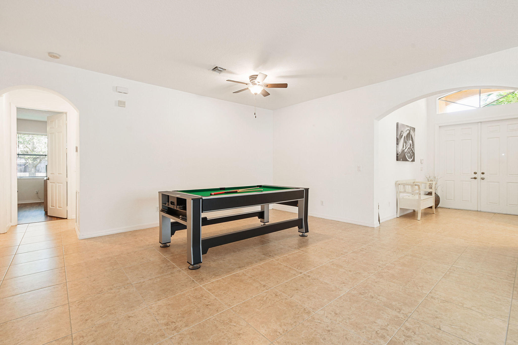 4100 Silverstone Drive Fort Pierce, FL 34947 - Photo 13 of 42 an empty room with windows and ceiling fan