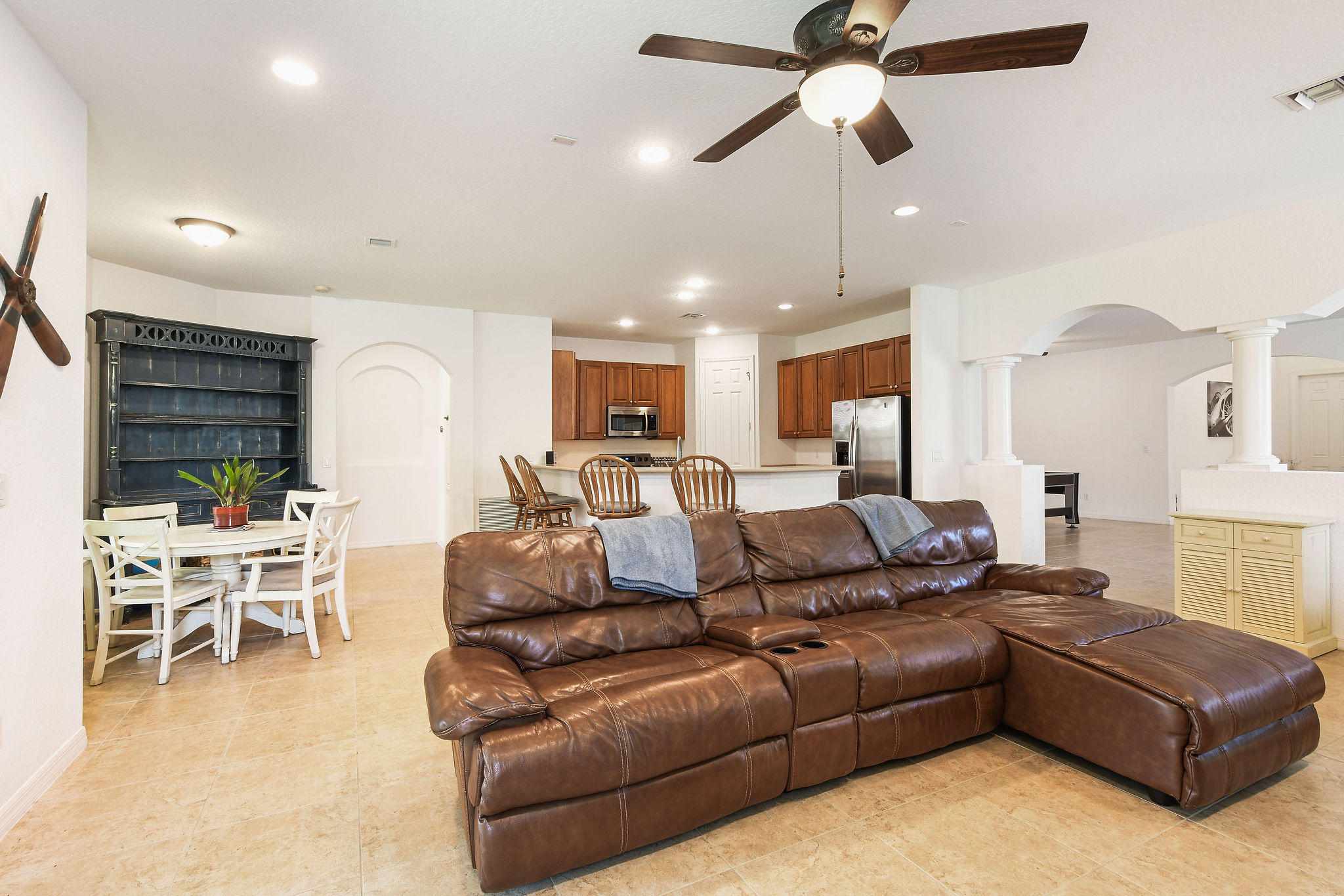 4100 Silverstone Drive Fort Pierce, FL 34947 - Photo 17 of 42 a living room with furniture kitchen view and a chandelier