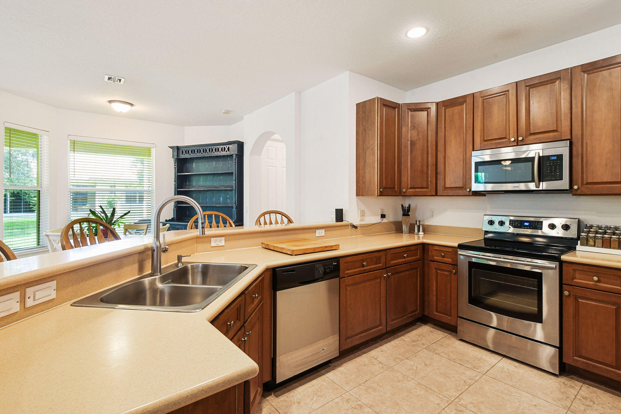 4100 Silverstone Drive Fort Pierce, FL 34947 - Photo 19 of 42 a kitchen with stainless steel appliances granite countertop a sink and a stove
