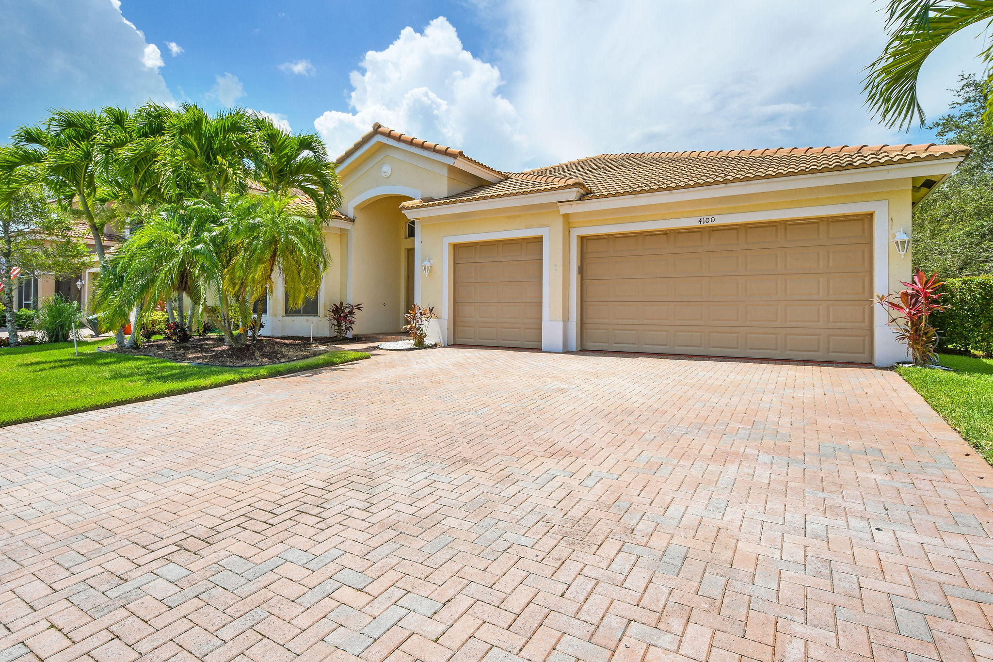 4100 Silverstone Drive Fort Pierce, FL 34947 - Photo 2 of 42 a front view of a house with a yard and garage