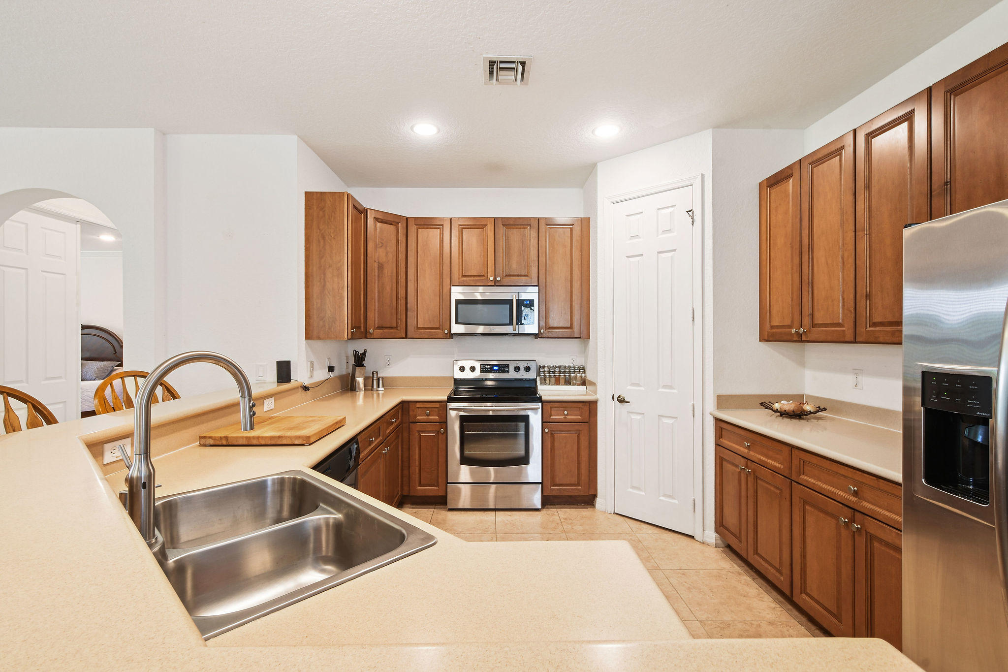 4100 Silverstone Drive Fort Pierce, FL 34947 - Photo 22 of 42 a kitchen with stainless steel appliances granite countertop a sink stove and refrigerator