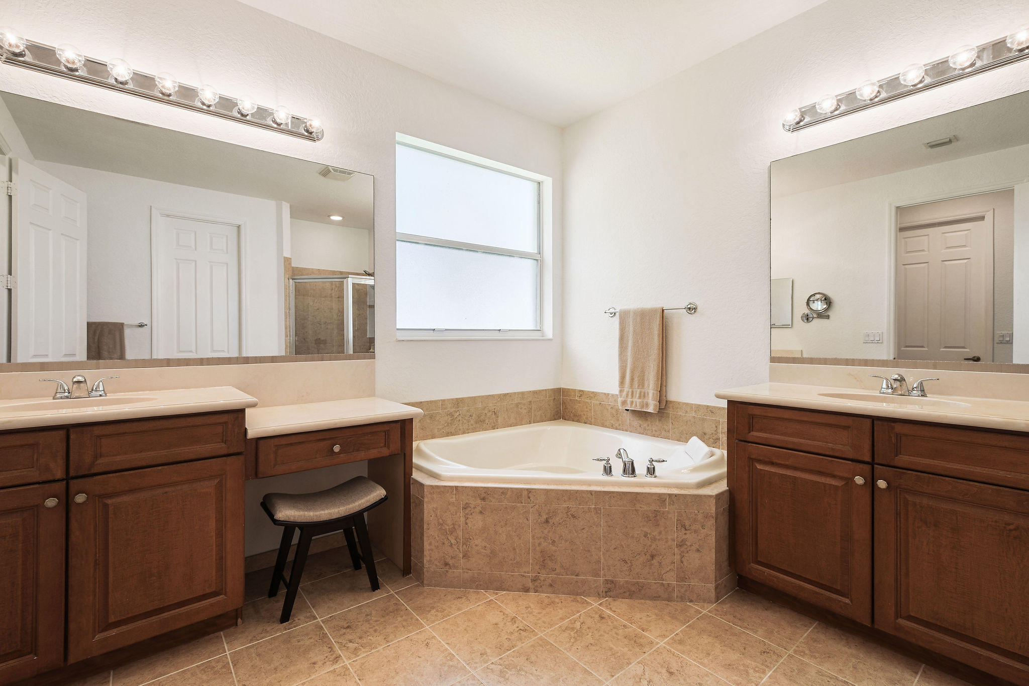 4100 Silverstone Drive Fort Pierce, FL 34947 - Photo 27 of 42 a bathroom with a tub a sink double vanity and a mirror