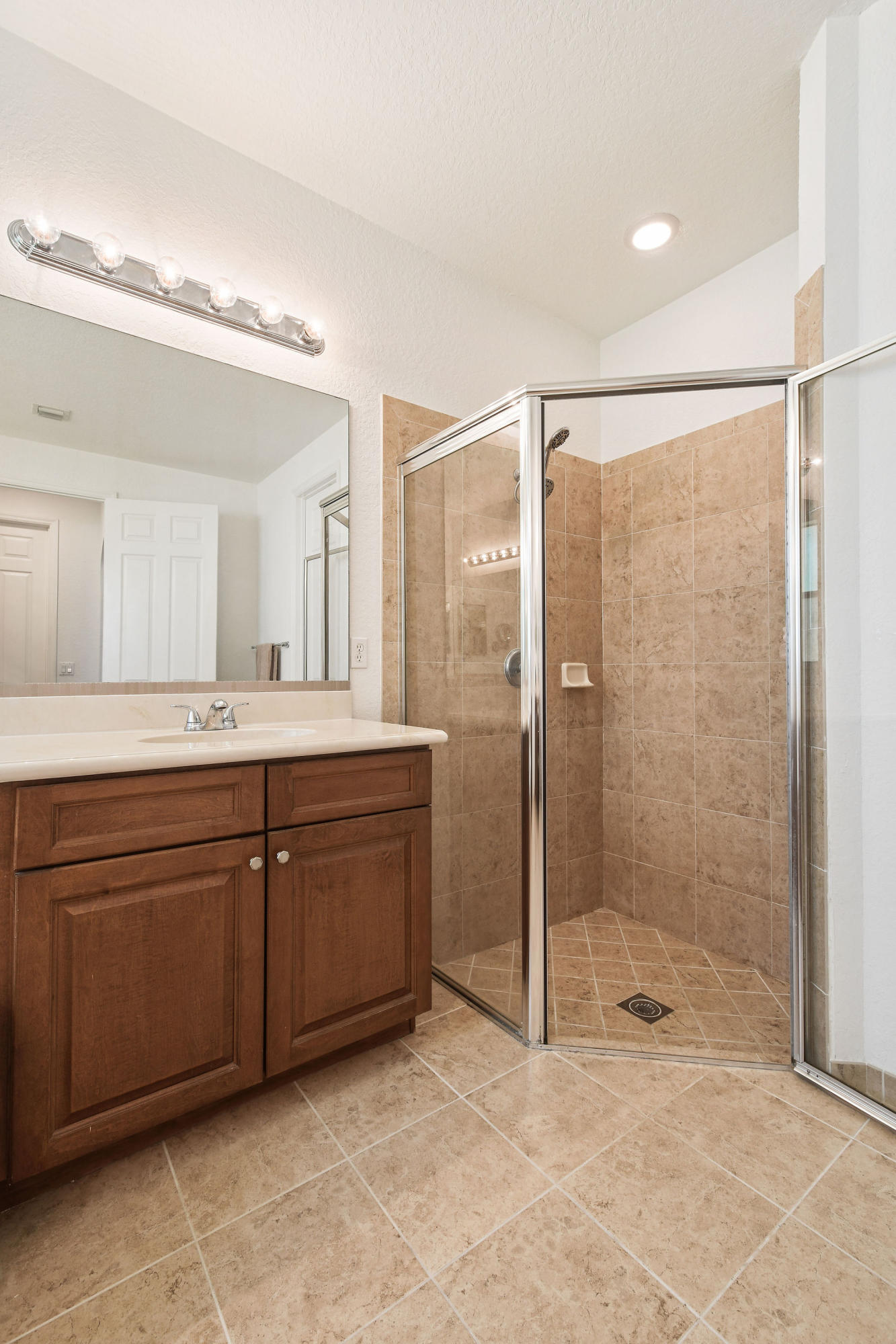 4100 Silverstone Drive Fort Pierce, FL 34947 - Photo 28 of 42 a spacious bathroom with a shower sink and mirror