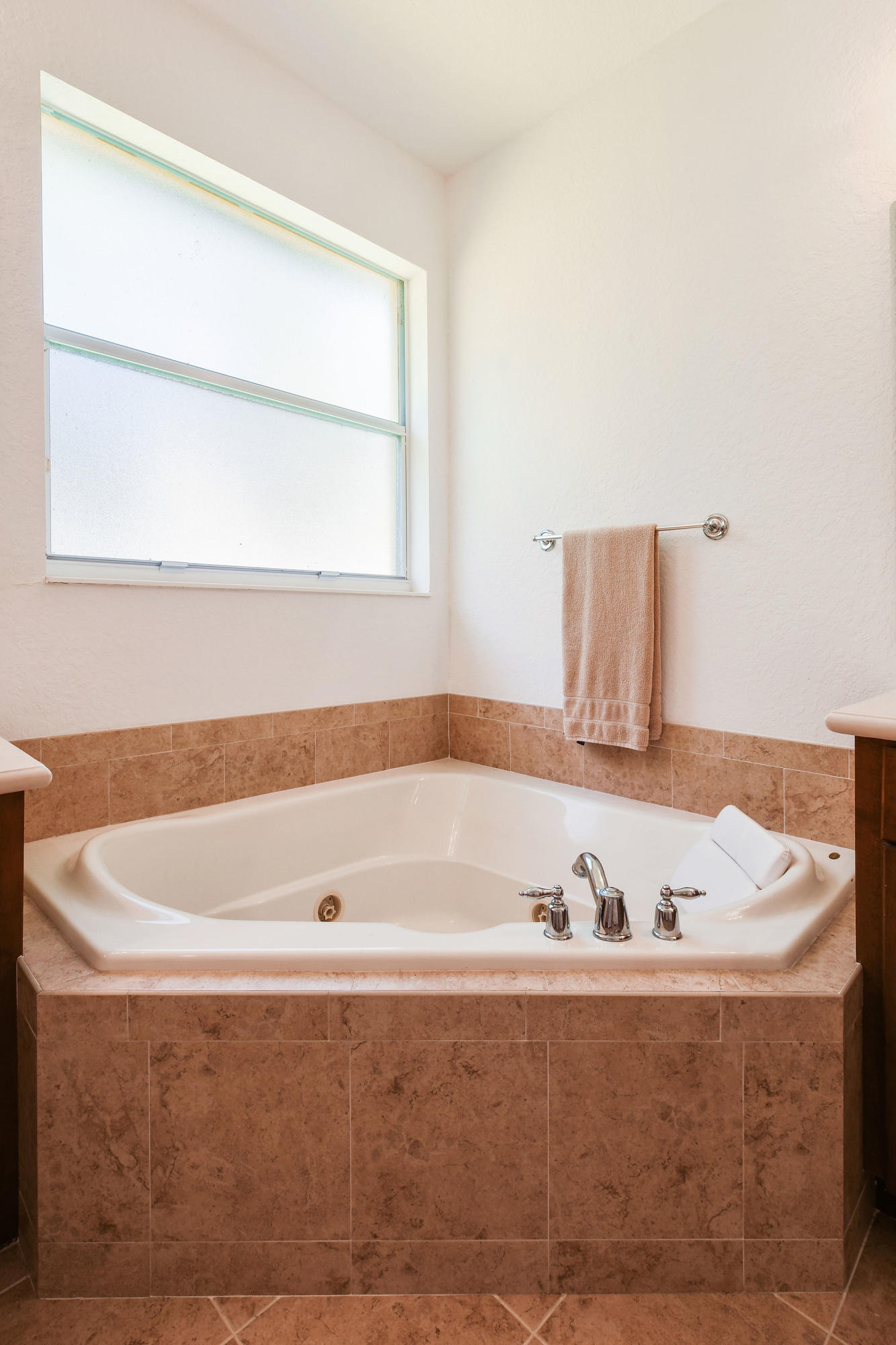 4100 Silverstone Drive Fort Pierce, FL 34947 - Photo 29 of 42 a bath tub sitting in a bathroom next to a window