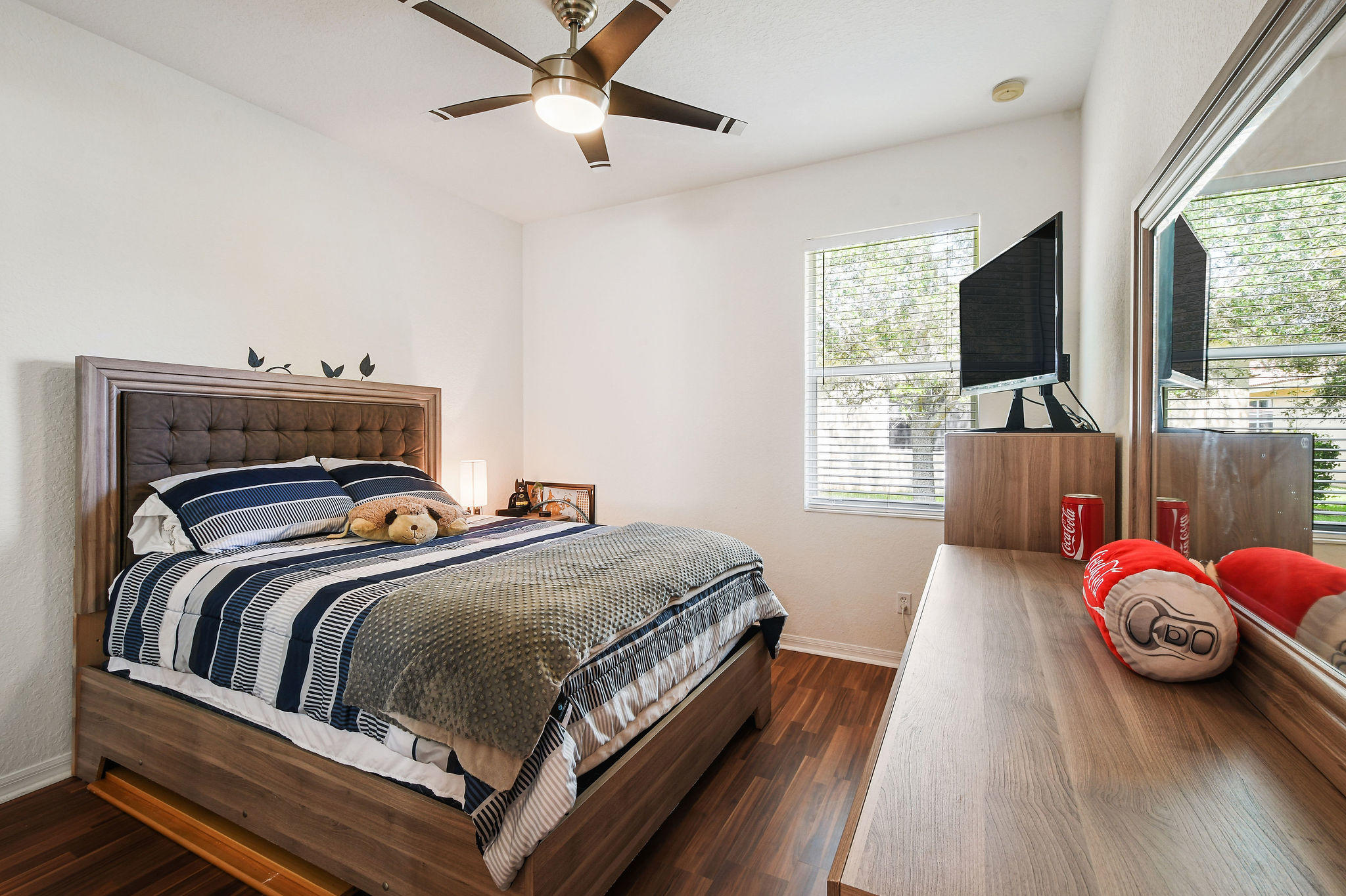 4100 Silverstone Drive Fort Pierce, FL 34947 - Photo 31 of 42 a bedroom with a bed and flat screen tv