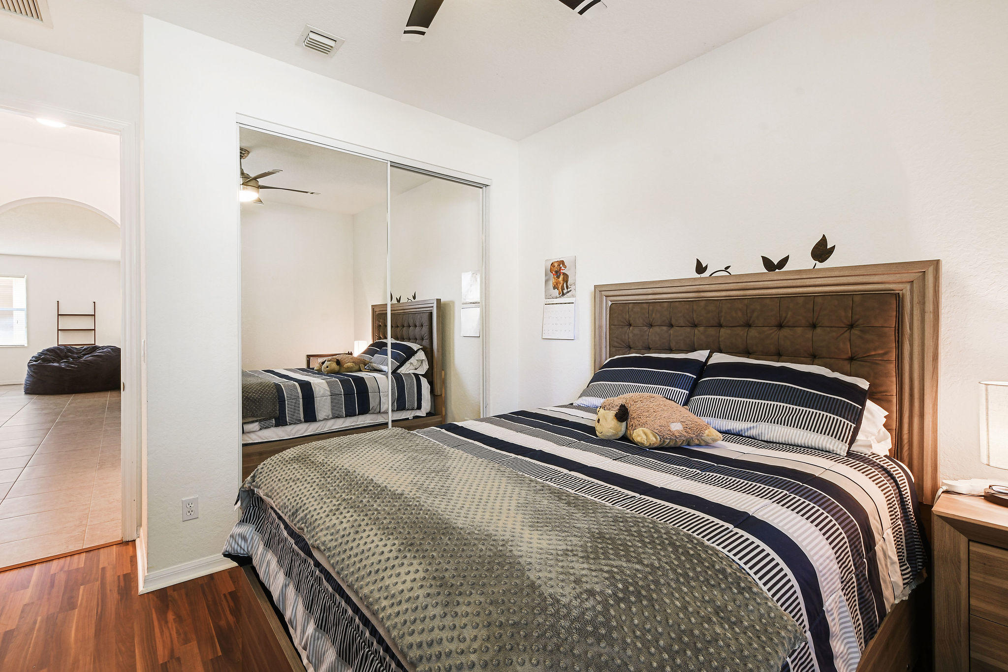 4100 Silverstone Drive Fort Pierce, FL 34947 - Photo 33 of 42 a bedroom with a bed and wooden floor