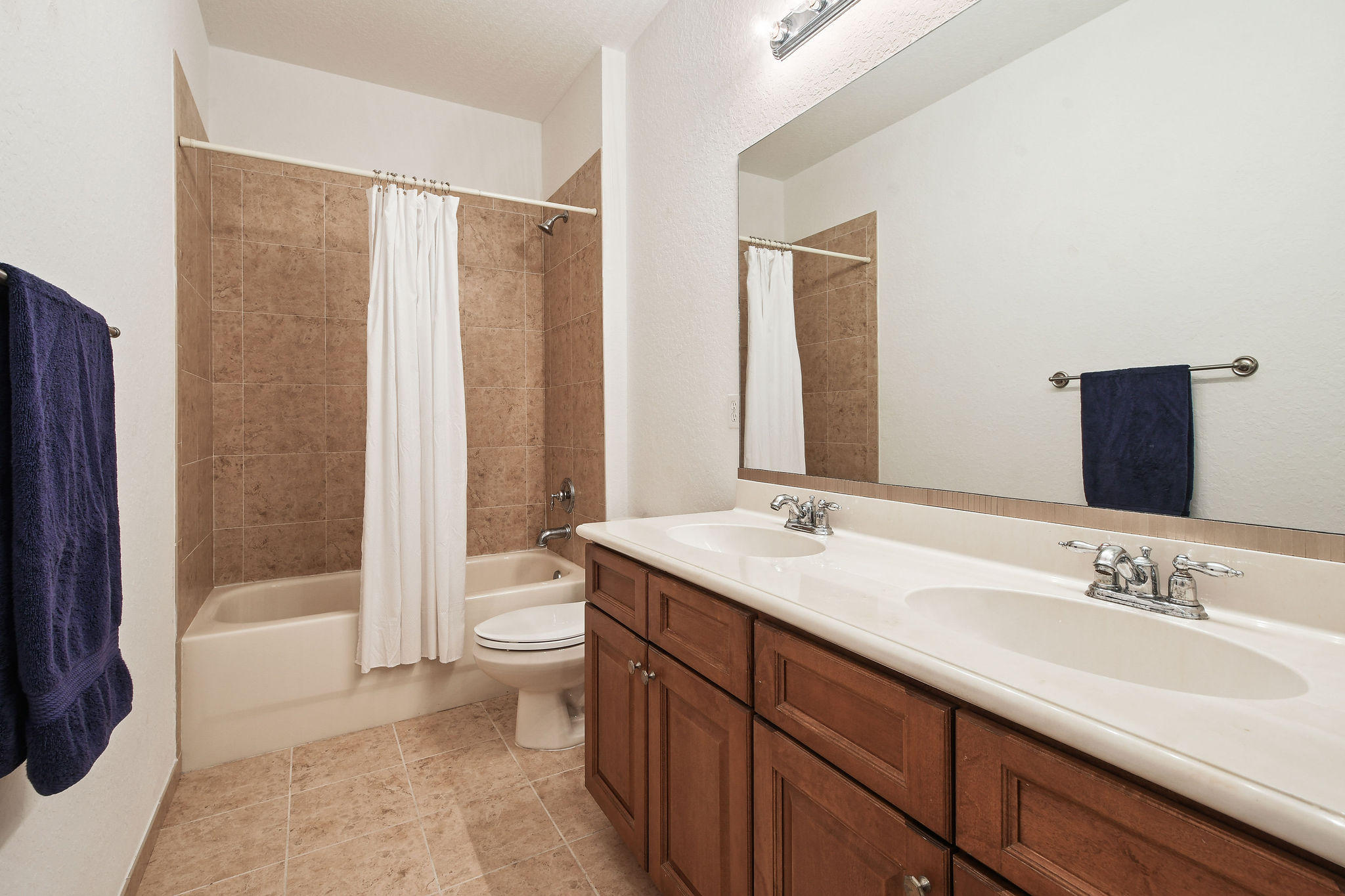 4100 Silverstone Drive Fort Pierce, FL 34947 - Photo 37 of 42 a bathroom with a double vanity sink toilet and shower