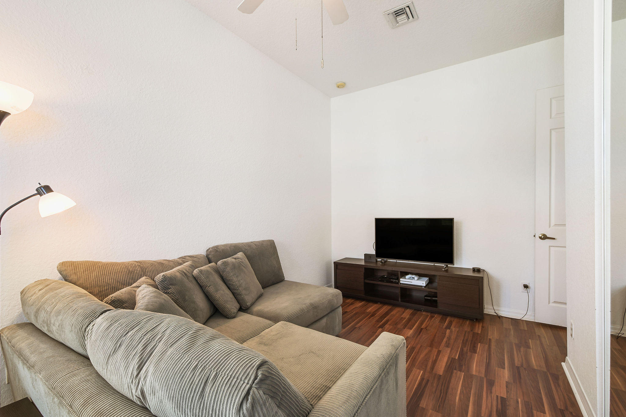 4100 Silverstone Drive Fort Pierce, FL 34947 - Photo 9 of 42 a living room with furniture and a flat screen tv