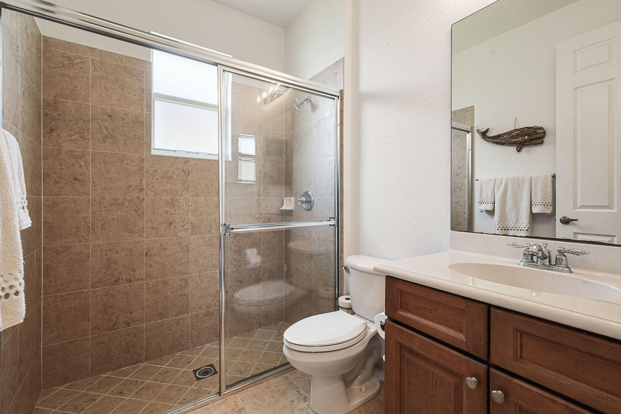 4100 Silverstone Drive Fort Pierce, FL 34947 - Photo 10 of 42 a bathroom with a sink toilet and shower
