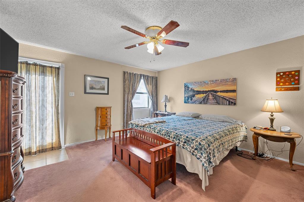 525 Angel Fire Drive Hewitt, TX 76643 - Photo 13 of 25 a bedroom with a bed and a chandelier
