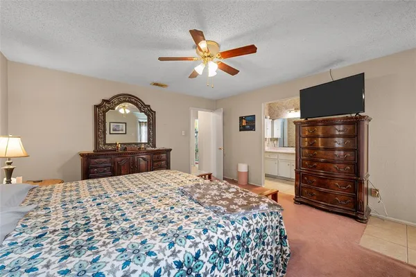a bedroom with a bed and a television