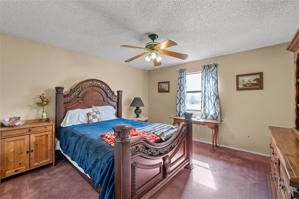 525 Angel Fire Drive Hewitt, TX 76643 - Photo 16 of 25 a bedroom with a bed and a chandelier