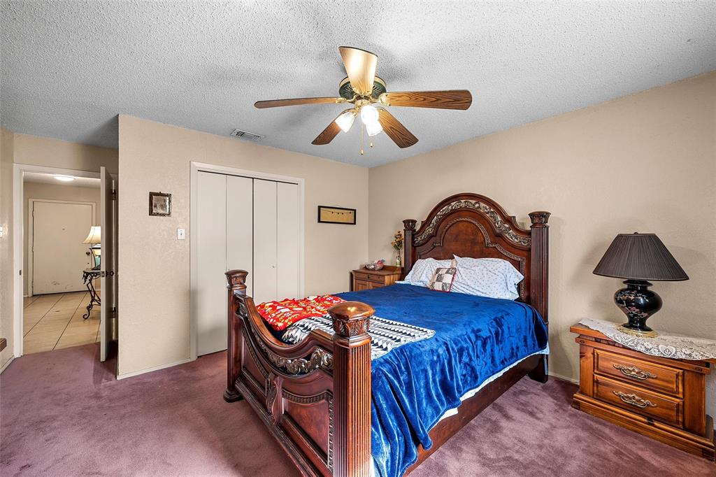 525 Angel Fire Drive Hewitt, TX 76643 - Photo 17 of 25 a bedroom with bed and a chandelier