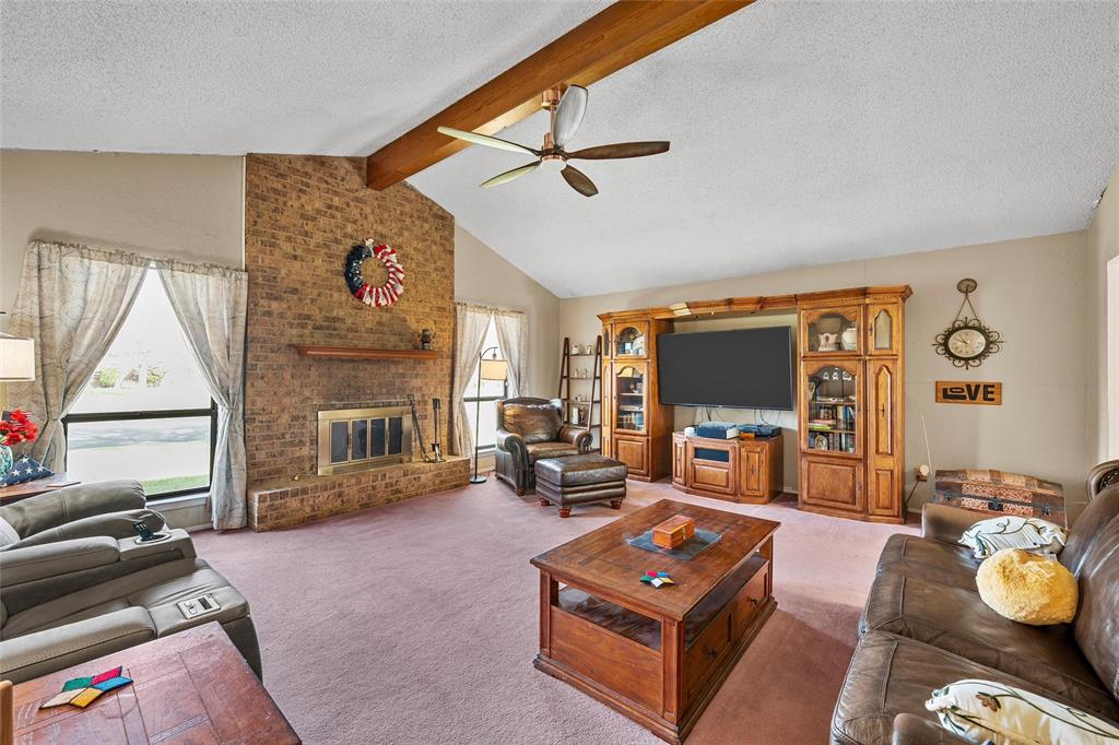 525 Angel Fire Drive Hewitt, TX 76643 - Photo 3 of 25 a living room with furniture a flat screen tv and a fireplace