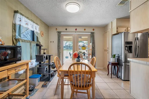 a dining room with furniture a fireplace a rug and a flat screen tv