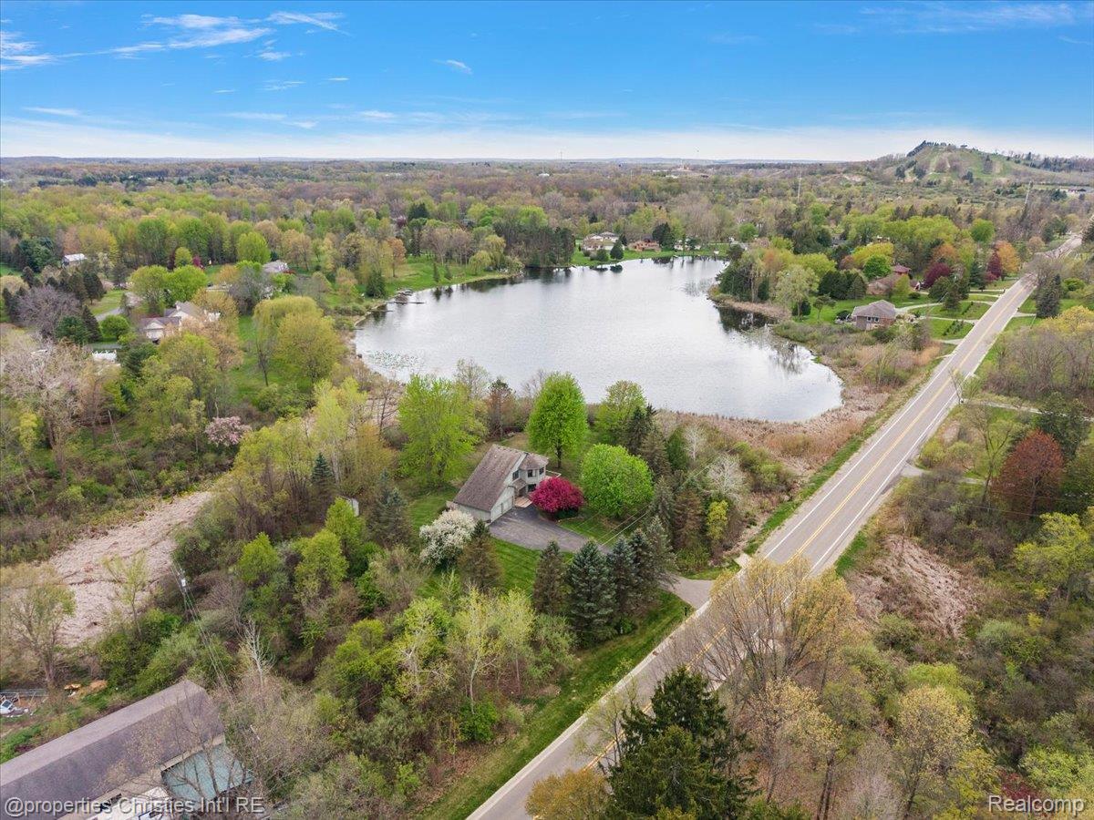6175 Tripp Road Holly, MI 48442 - Photo 54 of 63 Lakeside residence set amidst a verdant landscape with mature trees