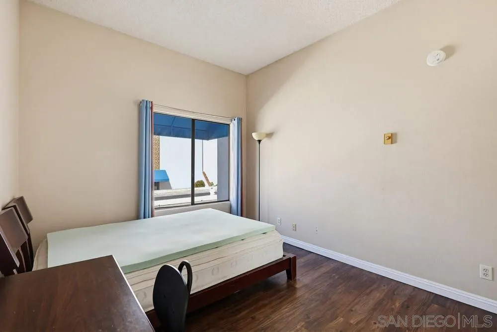 8324 Regents Road, Unit 2E San Diego, CA 92122 - Photo 23 of 31 a room with a bed and a window