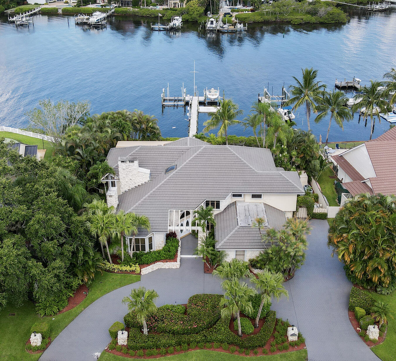an aerial view of a house with garden space and lake view