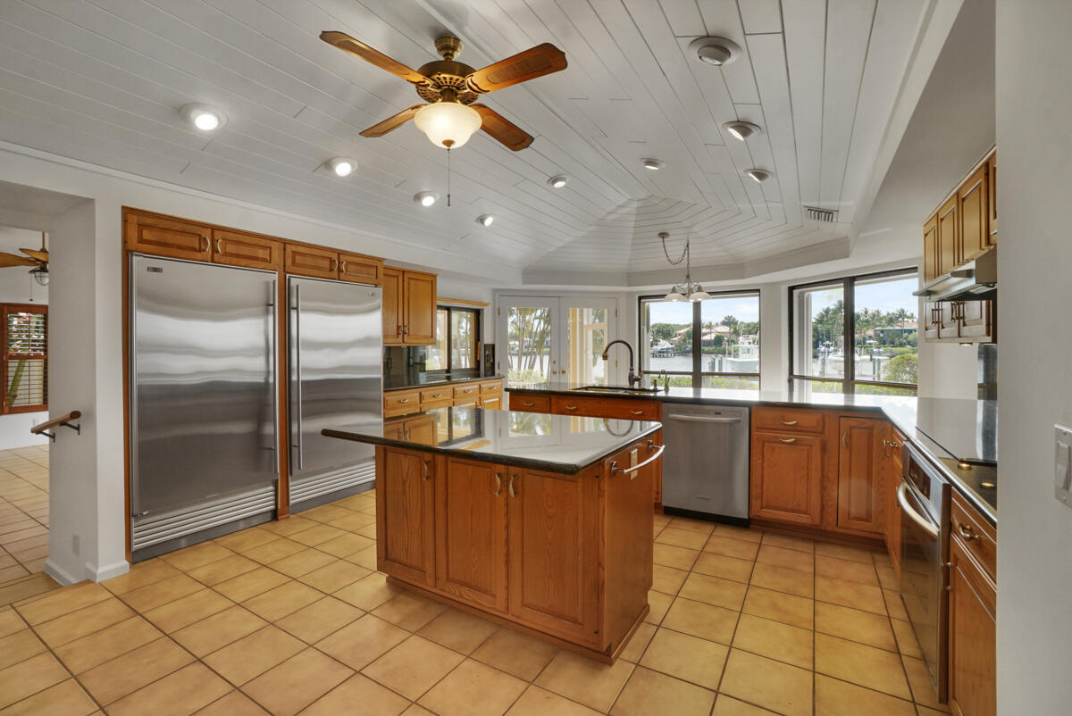 19842 Wilkinson Leas Road Jupiter, FL 33469 - Photo 25 of 75 a kitchen with stainless steel appliances granite countertop a sink and a refrigerator