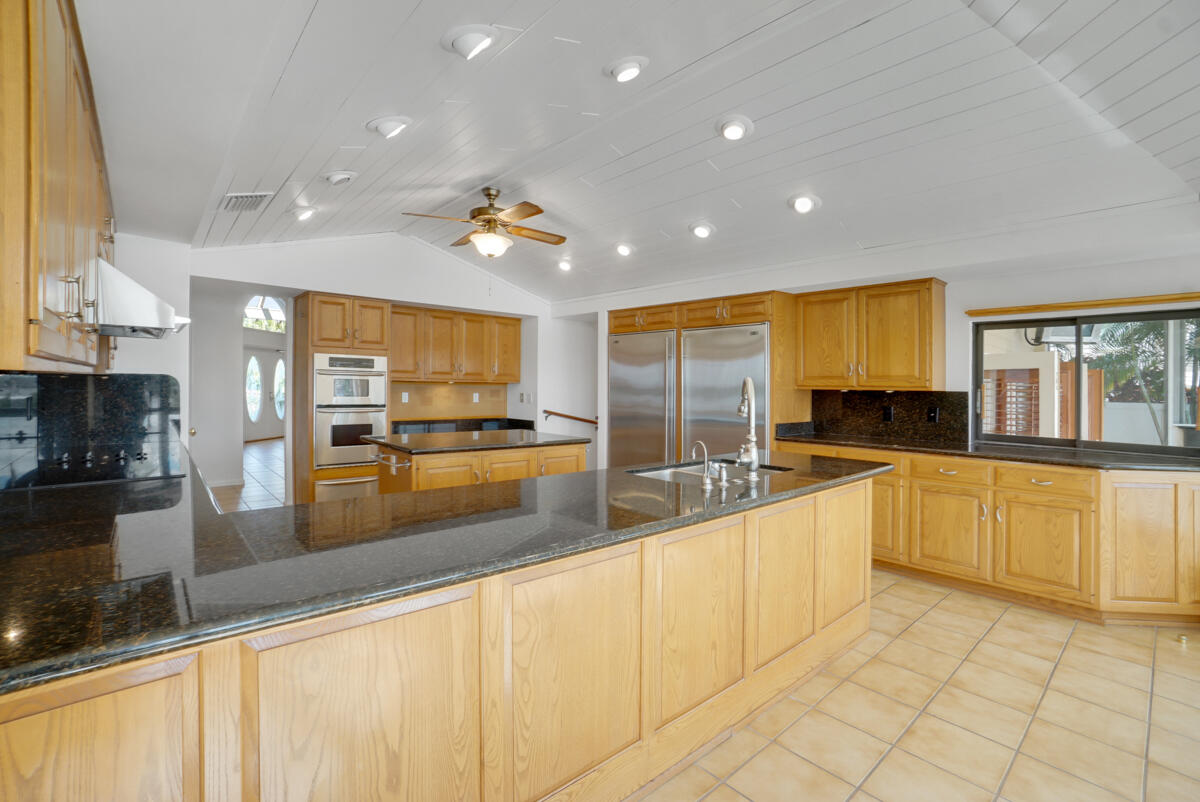 19842 Wilkinson Leas Road Jupiter, FL 33469 - Photo 28 of 75 a large kitchen with a large counter top appliances and cabinets