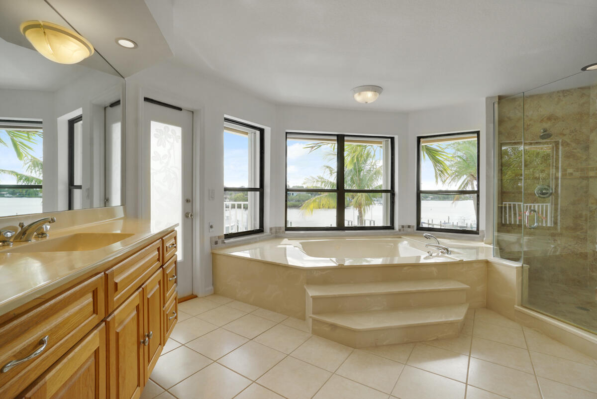 19842 Wilkinson Leas Road Jupiter, FL 33469 - Photo 34 of 75 a spacious bathroom with a tub a sink and mirror