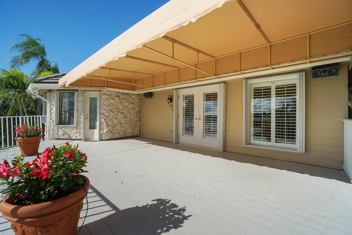 19842 Wilkinson Leas Road Jupiter, FL 33469 - Photo 38 of 75 a front view of a house having a garden