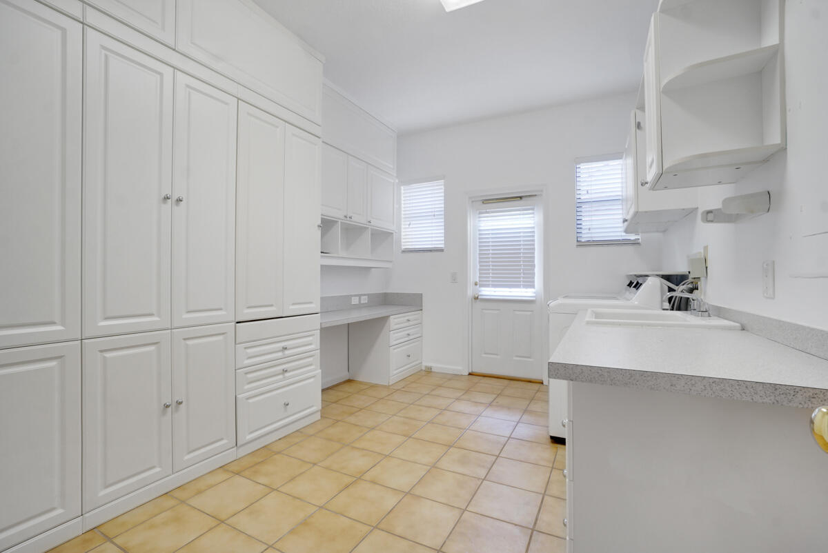 19842 Wilkinson Leas Road Jupiter, FL 33469 - Photo 42 of 75 a kitchen with a sink cabinets and appliances
