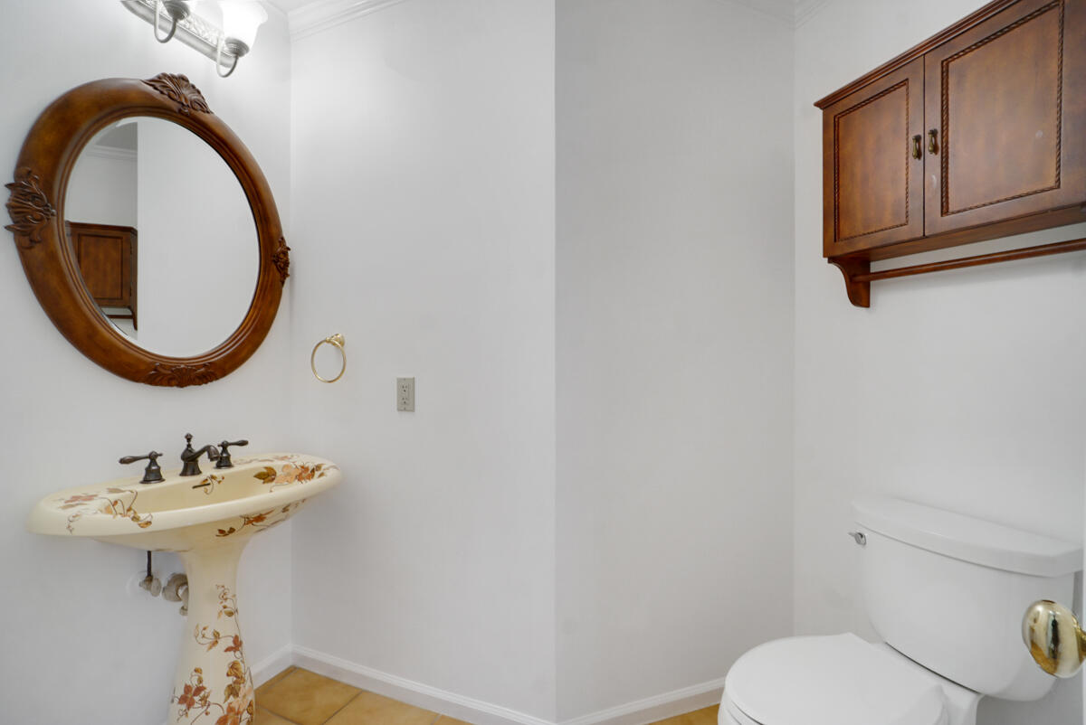 19842 Wilkinson Leas Road Jupiter, FL 33469 - Photo 45 of 75 a bathroom with a sink and a mirror