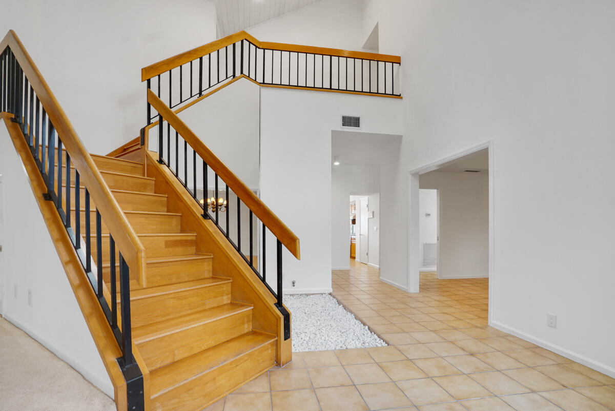 19842 Wilkinson Leas Road Jupiter, FL 33469 - Photo 46 of 75 a view of staircase with white walls and a window