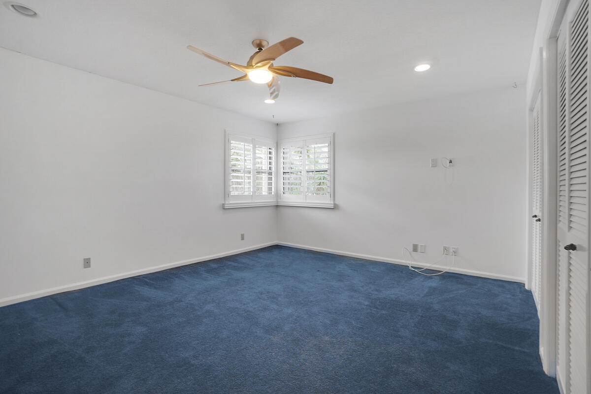 19842 Wilkinson Leas Road Jupiter, FL 33469 - Photo 56 of 75 an empty room with windows and fan